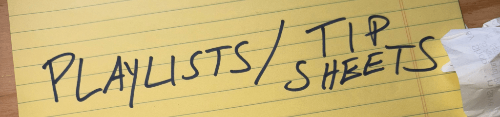 A yellow legal pad with Playlists / Tip Sheets written in blue magic marker.